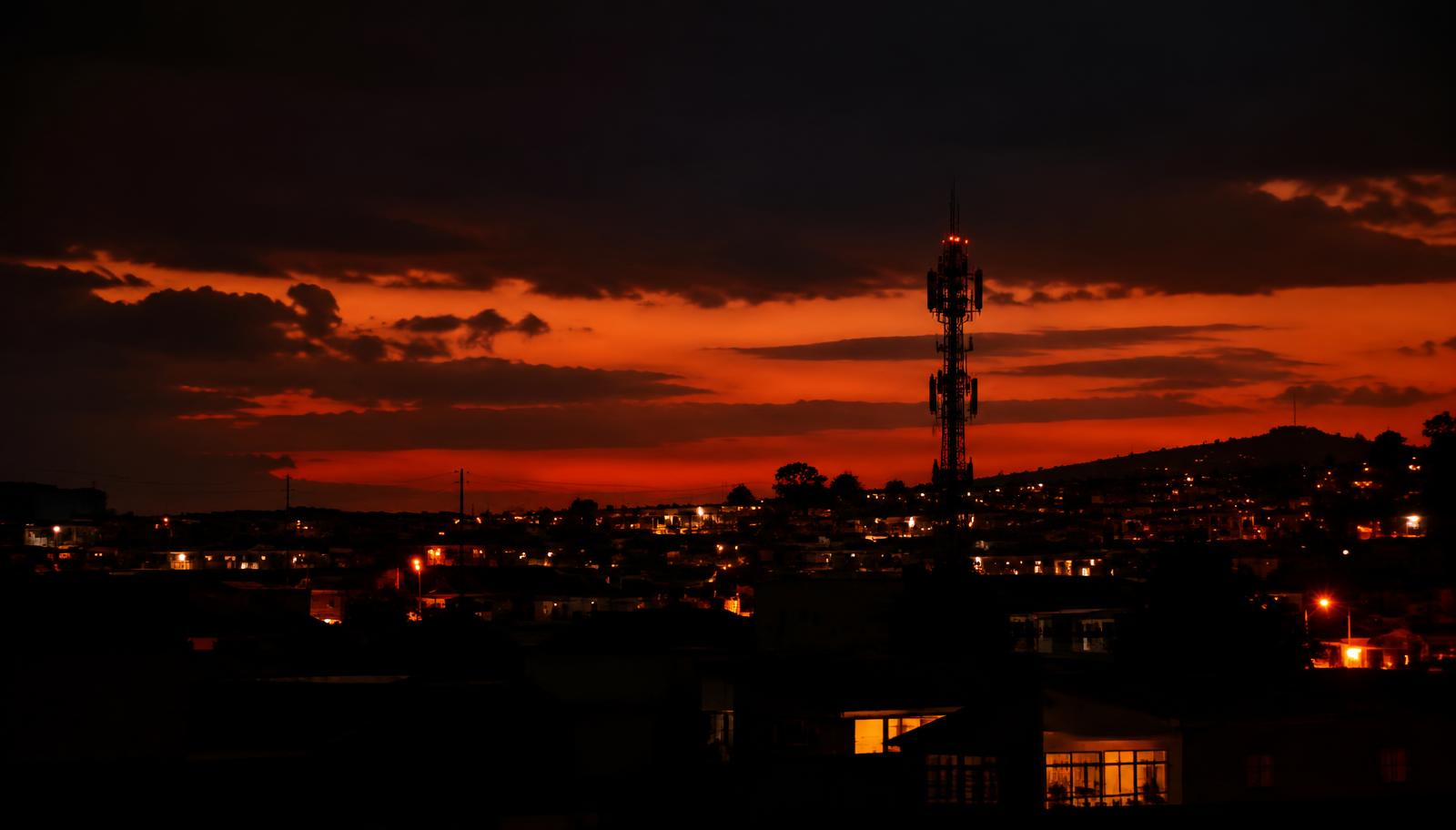South African community at dusk with a network tower